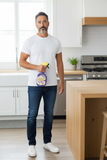 A man holding a bottle of Lavalosso cleaning spray in a kitchen